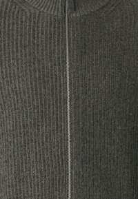 Dark gray ribbed sweater featuring a high collar and front zipper closure. The texture is soft with a slightly structured appearance.