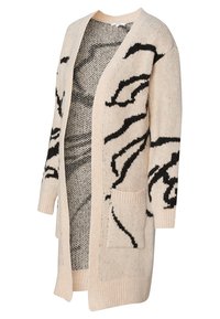 Béžový pletený kardigan s černými abstraktními vzory, otevřený vpředu, se dvěma kapsami a žebrovanými manžetami. Měkká textura, střední délka, volný střih.