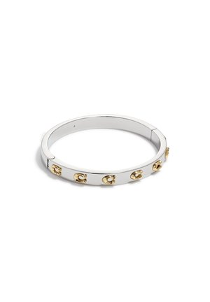 Silver bangle with a smooth finish, featuring gold hardware accents. Designed with a simple, rounded shape and five decorative links.