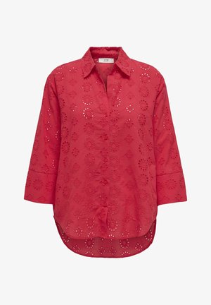 Punane nööbitav särk pikkade varrukatega, millel on lilleline tikand ja lõikeavad. Pehme kangas, millel on kaarduv äär.