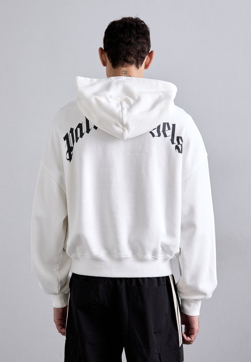 Weißer Kapuzenpullover mit schwarzem Text "Palm Angels" auf dem Rücken. Verfügt über eine lockere Passform, gerippte Bündchen und einen weichen, strukturierten Stoff.