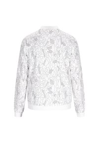 Witte bomberjack met een monochroom abstract lijnpatroon, geribbelde manchetten en kraag, met een relaxte pasvorm en zachte stoftextuur.