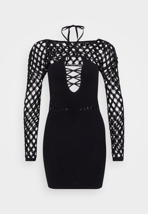 Mustapuku, jossa on pitkät kudotut hihat, joissa on ristikkorakenne, syvä V-pääntie ja aukot vyötärön kohdalla.