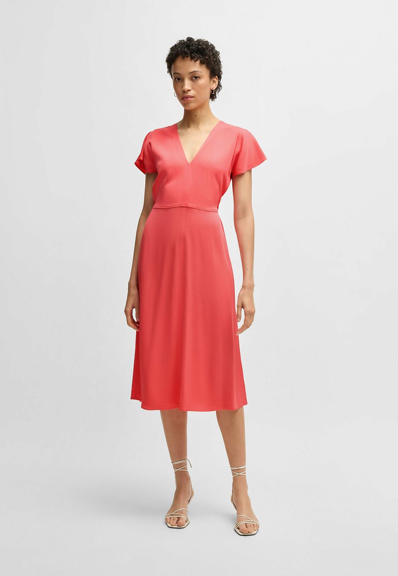 Pink knee-length dress featuring a V-neck, short flutter sleeves, and a fitted waist, made from lightweight, smooth fabric.