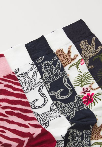 Multicolor socks featuring various patterns: pink and red zebra stripes, white and navy with animal designs, and floral accents on dark fabric.