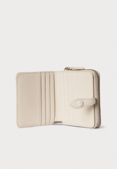 Μπεζ δερμάτινο πορτοφόλι με φερμουάρ, πολλαπλές υποδοχές για κάρτες και σούστες. Λιτή υφή και ραμμένες λεπτομέρειες. Κομψός συμπαγής σχεδιασμός.