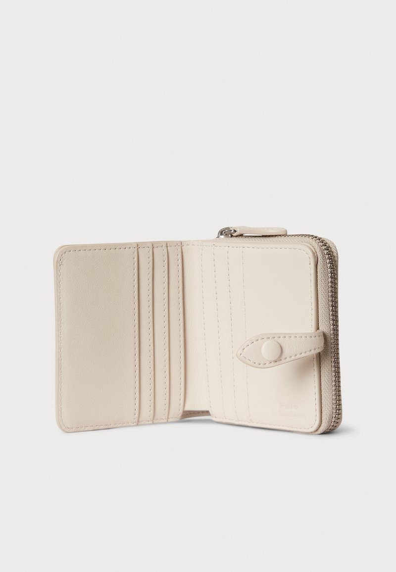 Beige Lederbrieftasche mit Reißverschluss, mehreren Kartenfächern und einem Druckknopf. Glatte Textur und gestickte Details. Kompaktes Design.