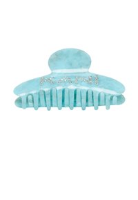 Aqua-colored hair clip made of glossy plastic, featuring a scalloped shape and embellished with rhinestones spelling "KANI."