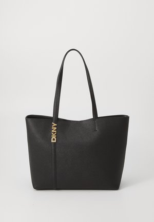 Black tote bag with textured synthetic material, dual handles, and a gold logo accent on the side. Open top design for easy access.