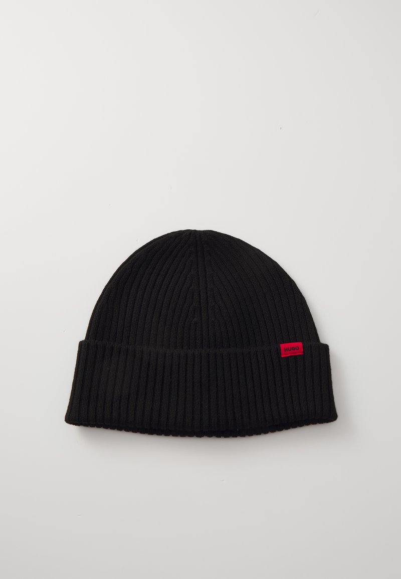Black knit beanie with a ribbed texture, featuring a folded cuff and a small red logo tag. The overall design is simple and monochromatic.
