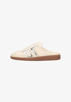 Cream-colored slip-on sneaker with silver "OT" logo on side and brown rubber sole labeled "BACK 70."