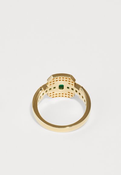 Gold ring with an octagonal design, featuring a green gemstone at the center and an open lattice pattern along the band.