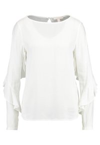 Vit långärmad blus med volangärmar och rund halsringning. Tillverkad i lätt tyg, med en nyckelhålslåsning bak.