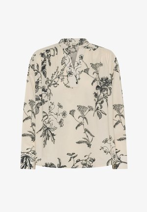 Blouse à manches longues en tissu crème, ornée d'un imprimé floral noir. Conçue avec un col classique et des détails plissés au niveau du col.
