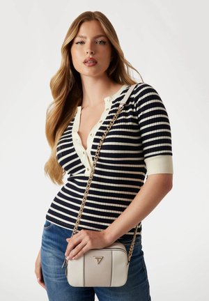 Striped knit top in navy and cream with short sleeves; paired with a beige crossbody bag featuring a gold chain strap and logo detail.