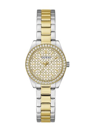 Ασημένιο και χρυσό δίχρωμο ρολόι Guess με στεφάνι διακοσμημένο με κρύσταλλα και διακοσμητικό καντράν με χρυσά σχέδια που δείχνει την ώρα.