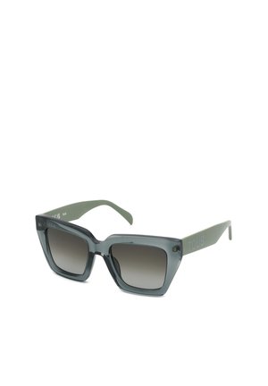 Lunettes de soleil carrées avec verres à dégradé foncé et montures épaisses semi-transparentes grises ainsi que branches vertes avec la marque "TOUS".