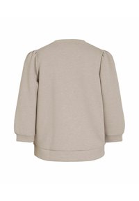Sweatshirt beige con scollo tondo, maniche a sbuffo e polsini a coste. Tessuto morbido con una consistenza liscia, design casual.