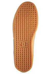 Gummisneaker-Sohle in Orange, mit einem strukturierten Wabenmuster und einem zentralen Logo. Leicht abgerundete Kanten mit glatter Oberfläche.