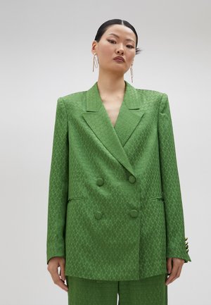 Green double-breasted blazer with a textured pattern, notched lapels, and two front pockets. Smooth fabric with slight sheen.