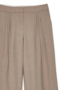 Beige pleated trousers made of textured fabric, featuring a flat front and belt loops, with a tailored fit and clean finish.
