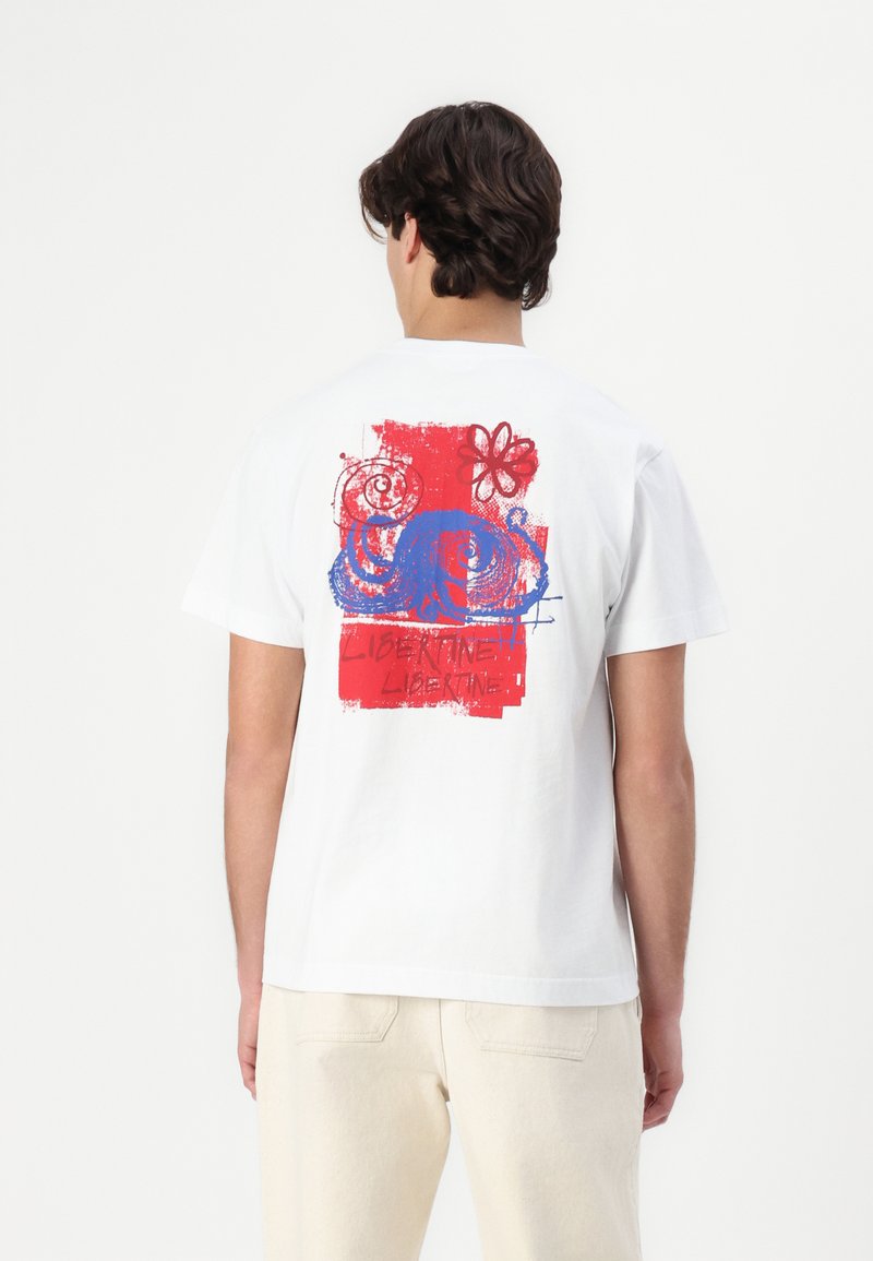 White cotton t-shirt featuring a colorful graphic print of an octopus and floral elements in red and blue on the back.