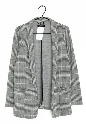 Blazer à carreaux gris avec un col cranté, une ouverture devant et deux poches avant. Le tissu a une apparence texturée et tissée avec un design structuré.