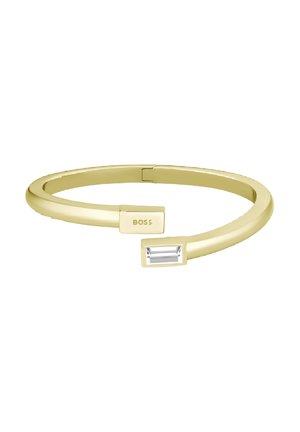 Bracciale rigido in tono oro con un design elegante e arrotondato. Presenta un accento di pietra trasparente rettangolare e dettagli incisi con il logo "BOSS".