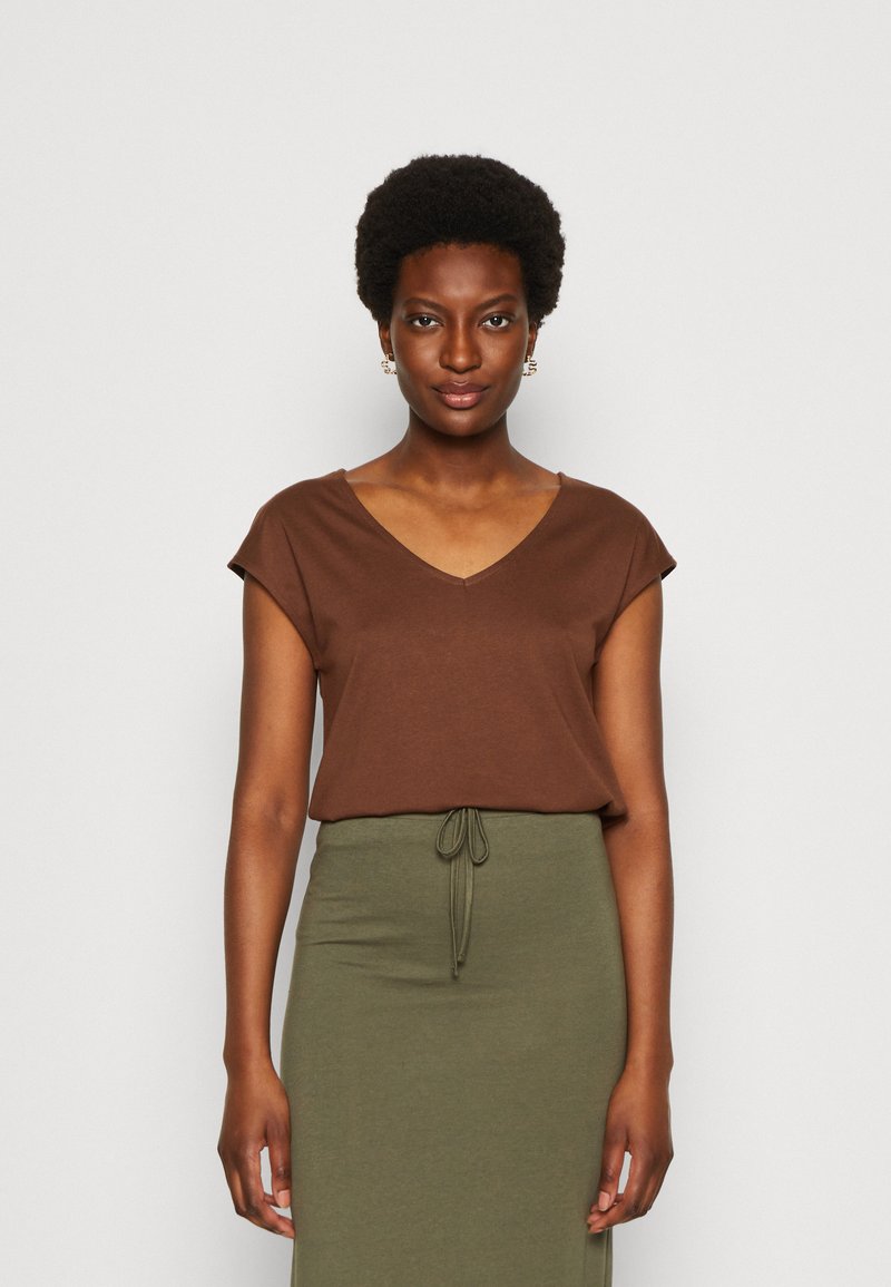Brown, short-sleeve V-neck top paired with a green, drawstring waist skirt. Soft fabric with a relaxed fit, minimal design.