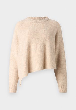 Beige cropped sweater with a round neckline, soft texture, and long sleeves. Features a slightly asymmetrical hem and ribbed cuffs.