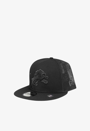 Black snapback cap with mesh back, embroidered lion logo on front, and brand logos on brim and side panel.