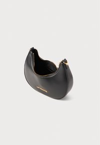 Black leather handbag with a curved shape, gold zipper hardware, and a logo embossed on the front. Open top reveals interior lining.