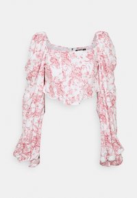 Top court blanc avec motif floral rouge, décolleté carré et longues manches bouffantes. Fait en tissu léger avec une finition texturée.