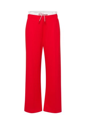 Pantalon large rouge en tissu doux avec une taille élastique et un cordon de serrage ajustable. Dispose de poches latérales et d'une texture lisse.