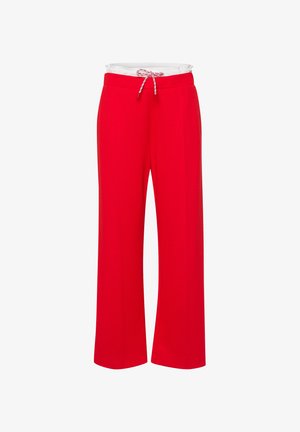 Red wide-leg trousers made of soft fabric with an elastic waistband and adjustable drawstring. Features side pockets and a smooth texture.