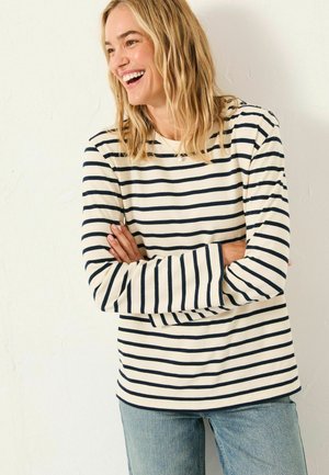 Langärmliges gestreiftes Oberteil in Creme mit navyblauen horizontalen Linien, mit gefütterten Ärmeln und einem runden Ausschnitt. Weiche Stofftextur.