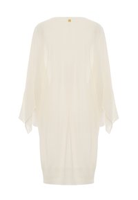 Maglione avorio con una vestibilità ampia, maniche a pipistrello e orlo a coste. Un piccolo tag con il logo è posizionato sul retro del collo.