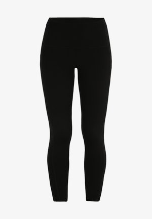 Černé legíny s vysokým pasem, vyrobené z elastického materiálu. Mají hladký, jemný povrch a přiléhavý, zúžený střih.
