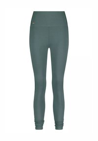 Hochtaillierte, lang geschnittene, dunkelgrüne Leggings ohne sichtbare Muster, mit leichtem Stoffraff in der Knöchelzone.