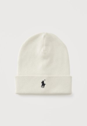 Bonnet en maille écru avec revers plié et petit logo brodé en noir représentant un joueur de polo centré sur le revers.