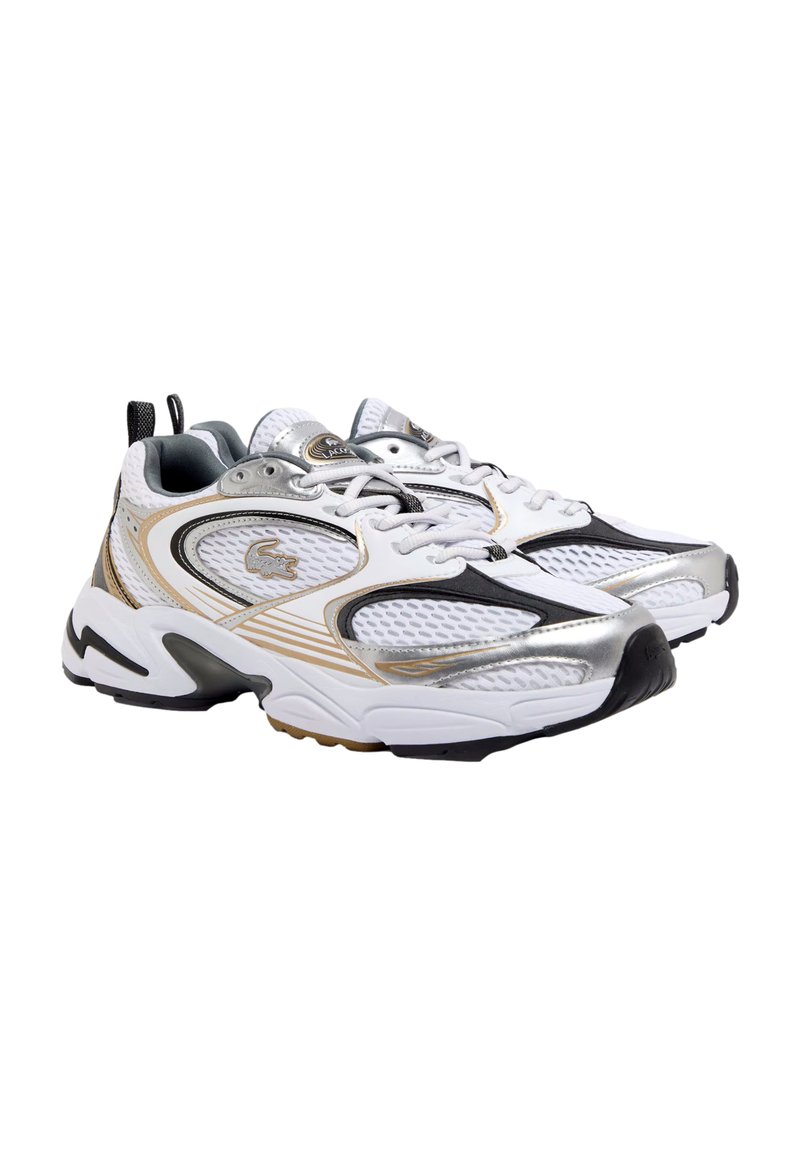Lacoste sneakers with a white mesh upper, silver and gold accents, black details, and a thick white sole. Features a logo on the side.