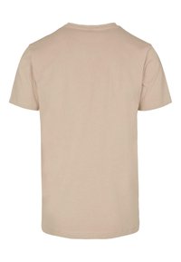 Kortærmet t-shirt i beige, lavet af blød bomuld. Har en rund halsudskæring og et enkelt, udekoreret rygdesign.