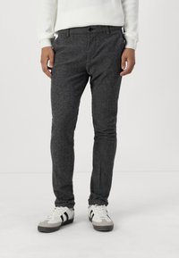 Gray, textured slim-fit pants with a standard waistband and front pockets, paired with white and gray sneakers.