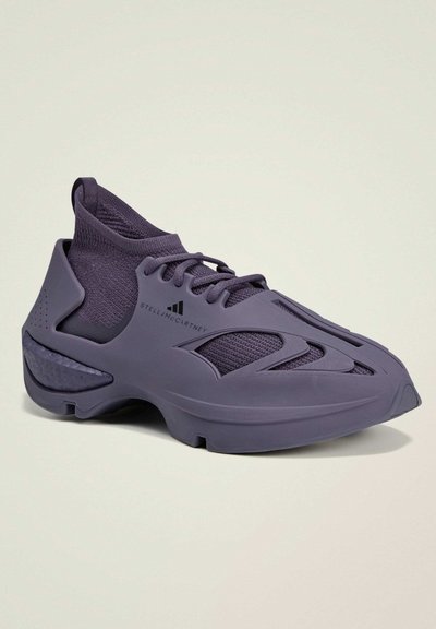 Purple athletic shoes with a knit upper and rubber sole. Features streamlined design, textured accents, and logo detail on the side.