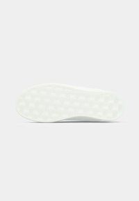 White sneaker sole with a textured pattern and logo detailing, featuring a smooth, flat surface ideal for traction.