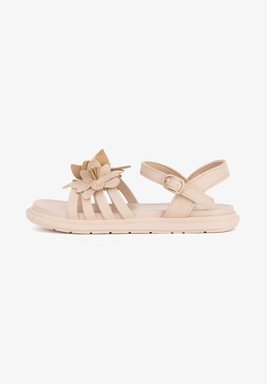 Beige Sandalen mit drei horizontalen Riemen und floralem Akzent. Mit verstellbarem Knöchelriemen und gepolsterter Sohle für Komfort.