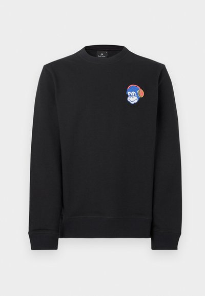 Sweat-shirt noir en coton à manches longues. Présente une tête de singe bleue brodée portant un casque audio sur la partie gauche de la poitrine.
