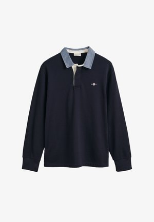 Tengerészhajó hosszú ujjú póló, pamut anyagból, denevér gallérral, fehér gombolással és egy kis hímzett logóval a mellkason.