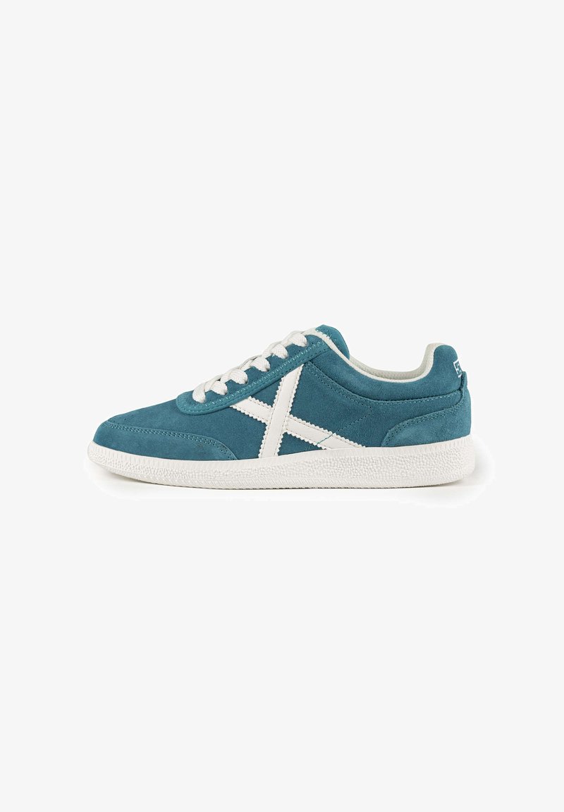Blue suede sneaker with white laces and accents. Features a textured white rubber sole and a prominent white X design on the side.