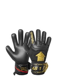 Black goalkeeper gloves with textured grip, padded fingers, gold accents, and adjustable wrist straps. Features logo and arrow design on back.